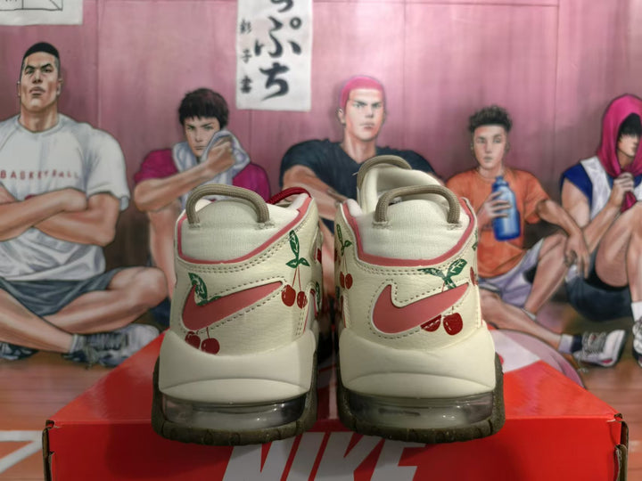 Rear view of cream Nike sneakers with red accents and cherry graphics