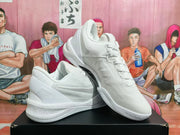 Side view of white Nike Kobe basketball shoes showing the Swoosh and signature detail