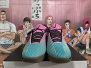 Front view of pink and blue Nike basketball shoes with black laces