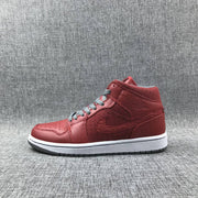 Full lateral profile of a red high-top sneaker with gray laces and a white midsole.