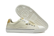 Cream sneaker side profile beside a view of the patterned outsole.