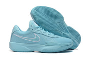 Light-blue Nike G.T. Cut Academy shoes with one outsole facing the camera to show the tread pattern
