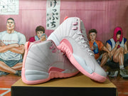 Pair of white and pink Jordan high-top sneakers arranged to show the side panels and pink outsole.