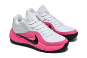 Pair of white and pink Nike 998-9 sneakers shown from an angled front perspective.