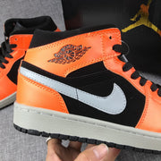 Close-up of the grey Swoosh, orange ankle panel and black side panel.