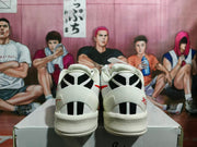Rear view showing black-and-white heel panels, white padded collars, and red accent details.