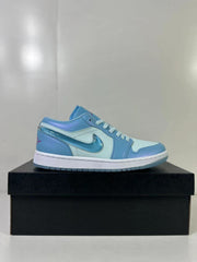 Side profile of the blue and light blue low-top sneaker on a black shoebox.