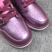 Close-up of the perforated pink rose toe box and burgundy laces.
