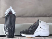 Front and side view highlighting the glossy black toe, woven-look upper panel, and white textured upper.