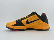 Side profile of the orange-and-black shoe with a Swoosh and orange midsole.