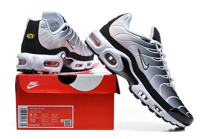 Nike Air Max Plus sneakers in black, grey, and pale pink displayed on a shoebox with a size label