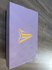 Light purple shoe box with a gold-colored basketball logo