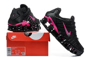 Black and pink Nike Shox TL sneakers displayed with a Nike shoebox and visible size label