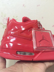 Side close-up of a red high-top sneaker with a removable-looking rectangular hangtag and visible heel air window.