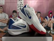 Pair of white basketball shoes showing blue heel accents and red outsole sections