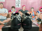 Rear view showing the black heel panels and pink Converse branding.