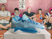 Side view showing the blue and sky-blue upper, sculpted white sole, and ribbed heel panel.