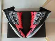 Top view of the pair highlighting the red laces and patterned overlays