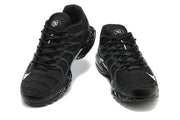 Front view of a pair of black Nike sneakers with wavy side cages and speckled soles.