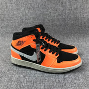 Pair of black and orange Air Jordan 1 Mid sneakers with grey side accents.