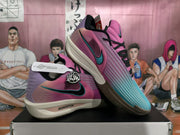 Angled view of the pink and blue basketball shoes with Swoosh accents