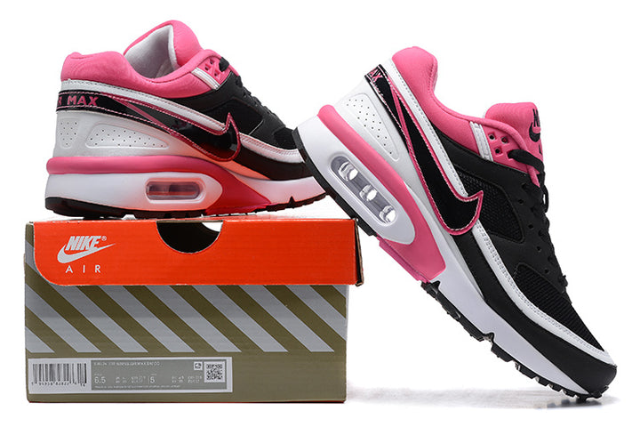 Black, white and pink Nike Air Max BW-style sneakers shown beside a shoebox.