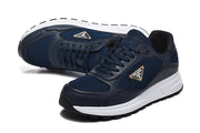Pair of navy mesh-panel sneakers shown at an angle with white midsoles.
