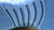 Detailed view of the outsole traction channels and printed text.