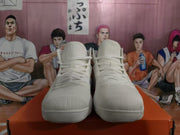 Front view of a pair of white high-top basketball sneakers with tonal laces and padded collars.