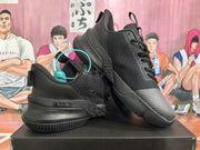 Angled view of two black Nike basketball sneakers showing the textured side panels and outsole details.