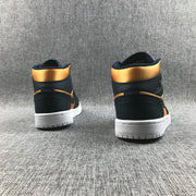 Rear view of a pair of black and metallic gold high-top sneakers showing the padded collars and white outsoles.