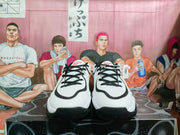 Front view of white, black, and red Jordan basketball sneakers with black laces.