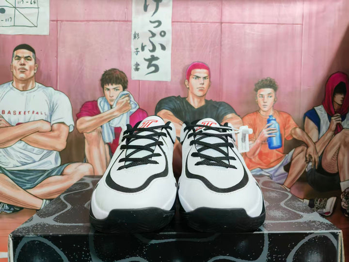 Front view of white, black, and red Jordan basketball sneakers with black laces.