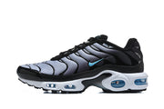 Side view of a Nike Air Max Plus sneaker with a silver-gray wavy upper, blue Swoosh, and white midsole.