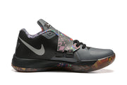 Side view of a gray and black Nike KD 4 shoe with a patterned strap and outsole.
