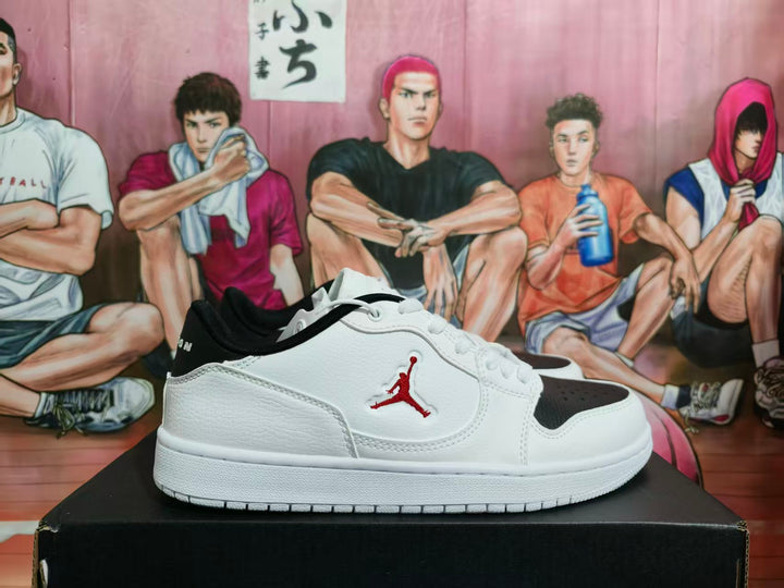 Side view of a white and black low-top Jordan sneaker with a red side emblem on a black shoebox.