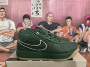 Side view of a green low-top sneaker with a contrasting Swoosh, wavy stitching, and gum-colored outsole.