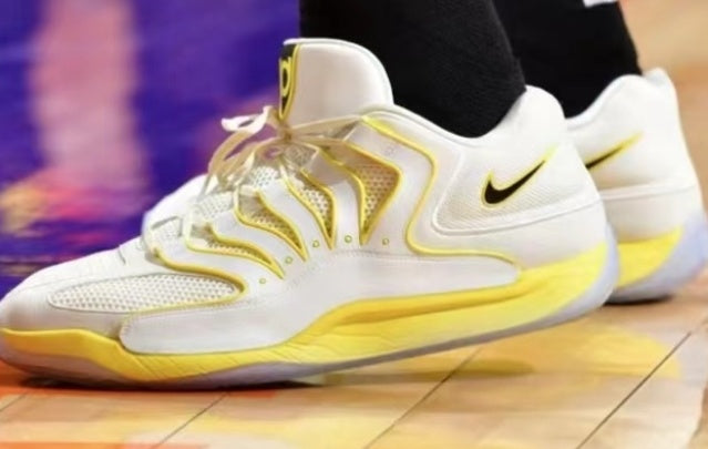 White and yellow Nike sneakers with layered upper detailing and a black Swoosh.