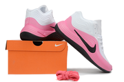 White and pink Nike basketball sneakers shown with an orange shoe box and spare pink laces.