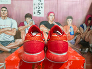 Rear view showing the red heel panels, textured collars, and layered red-and-white outsole.