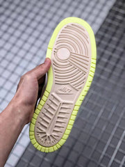 Bottom view showing the circular traction pattern and textured beige and yellow-green outsole.