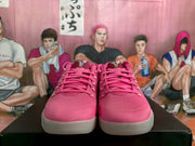Front view of the pair of pink Nike basketball sneakers with matching laces and textured toe boxes.