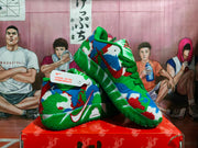 Angled view of green multicolor Nike basketball sneakers displayed on a shoebox.