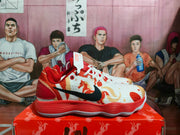 Side profile of the white, red, and orange basketball-style sneaker with black side branding and a layered outsole.
