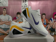 Angled side view highlighting the purple Swoosh, yellow heel accent, black textured insert, and white outsole.