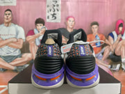 Rear view showing the patterned heel sections, Nike branding, black cushioning details, and purple-orange outsole accents.