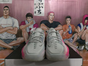 Top-front view of the pair showing grey toe boxes, lace-up fastening, ventilation details and pink side accents.