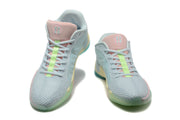 Pair of pastel blue Nike Sabrina basketball shoes with pink tongues and lime green lace details, viewed from the front.