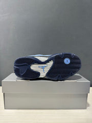 Jordan Air Jordan 14 sneaker shown from below with a patterned outsole and visible Jordan logo.