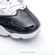 Close-up of the glossy black toe overlay, perforations and purple Jordan logo.